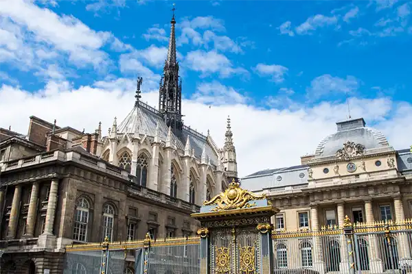 The front entrance of the Palais de Justice and Sainte-Chapelle chapel in Paris, France in sunny summer day - architecture background