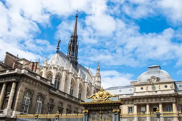 The front entrance of the Palais de Justice and Sainte-Chapelle chapel in Paris, France in sunny summer day - architecture background